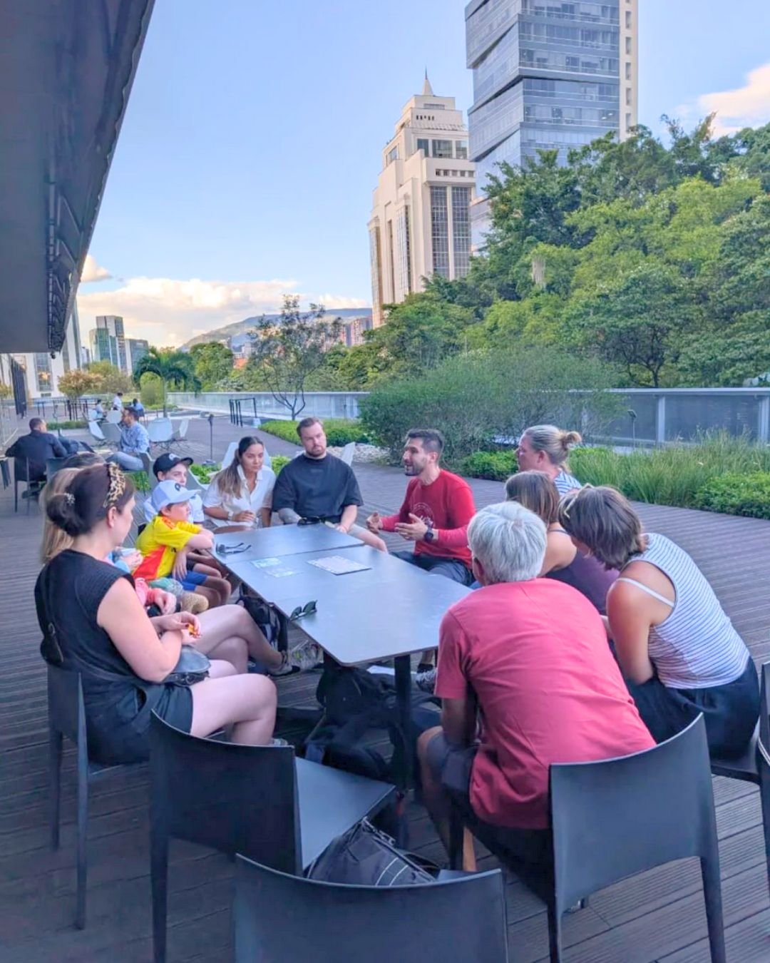 Travelers reflecting at a historic site with panoramic city views