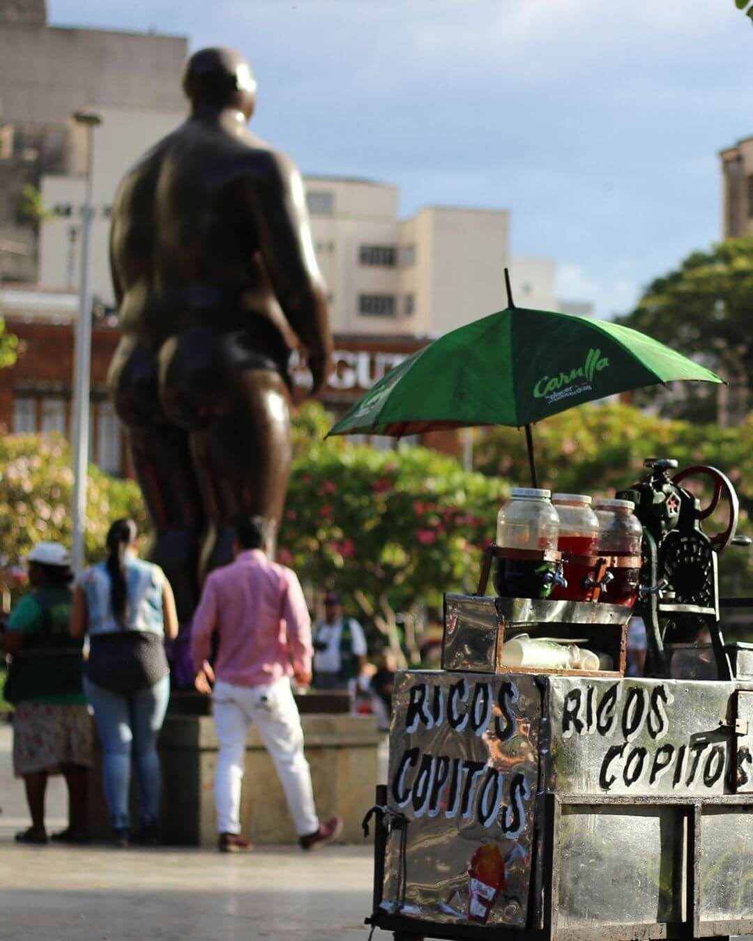 Tourists exploring the old and modern contrasts of downtown Medellin