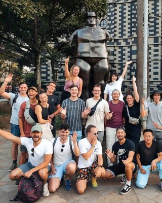 Group of people posing with statue during Medellin Local Food Tour