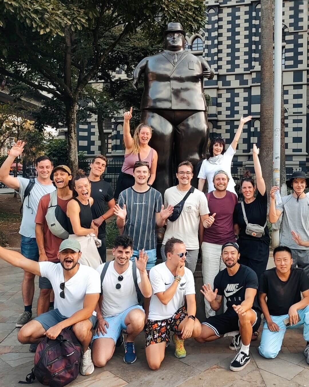 Group of people posing with statue during Medellin Local Food Tour