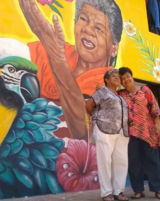 Street art mural showing transformation and resilience in Medellin