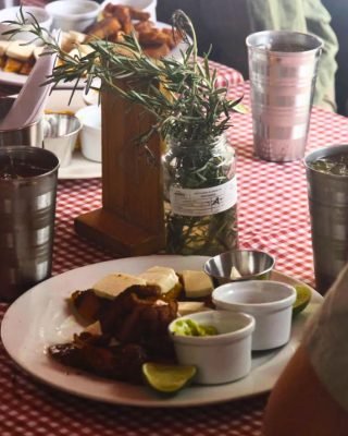 Local cook serving arepas and chicharrón during Medellin Local Food Tour