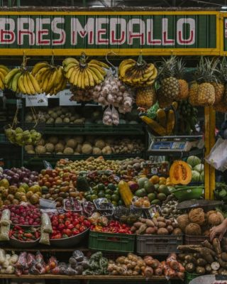 Colorful fruit stalls with mangoes, papayas, and passion fruit