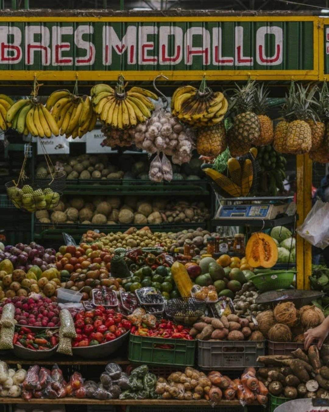 Colorful fruit stalls with mangoes, papayas, and passion fruit