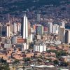 View over Medellin downtown with Metro and mountains.