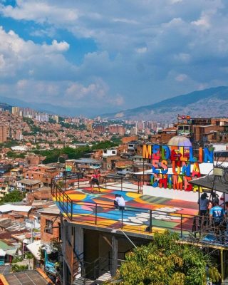Tourists exploring Medellin’s Comuna 13 with panoramic city views