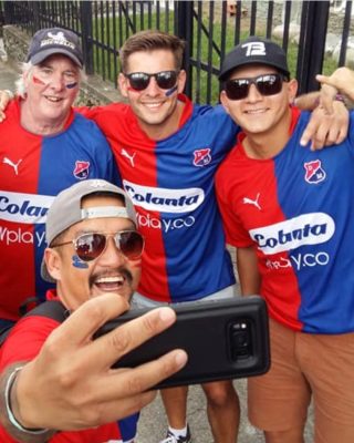 Tour group enjoying live football in Medellin