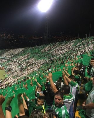 Local guide explaining football culture on Medellin Football Tour