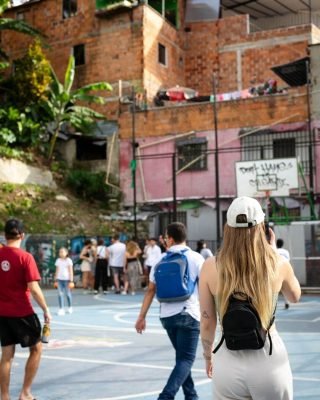 Local guide explaining graffiti and community history in Comuna 13 Medellin