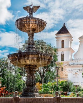 Plaza Mayor of Santa Fe de Antioquia with palm trees and cathedral view