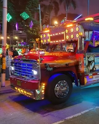 Locals and travelers celebrating together on Medellin’s iconic Chiva bus.