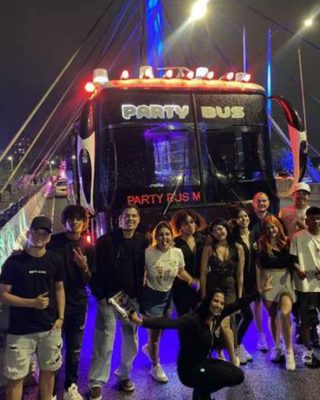 Party bus with neon lights cruising through Medellin at night.