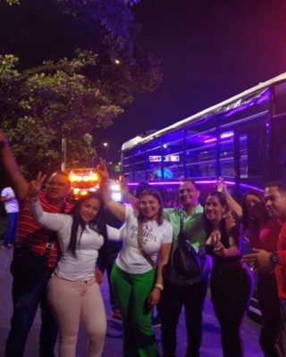 Group of travelers celebrating on a Medellin nightlife tour.